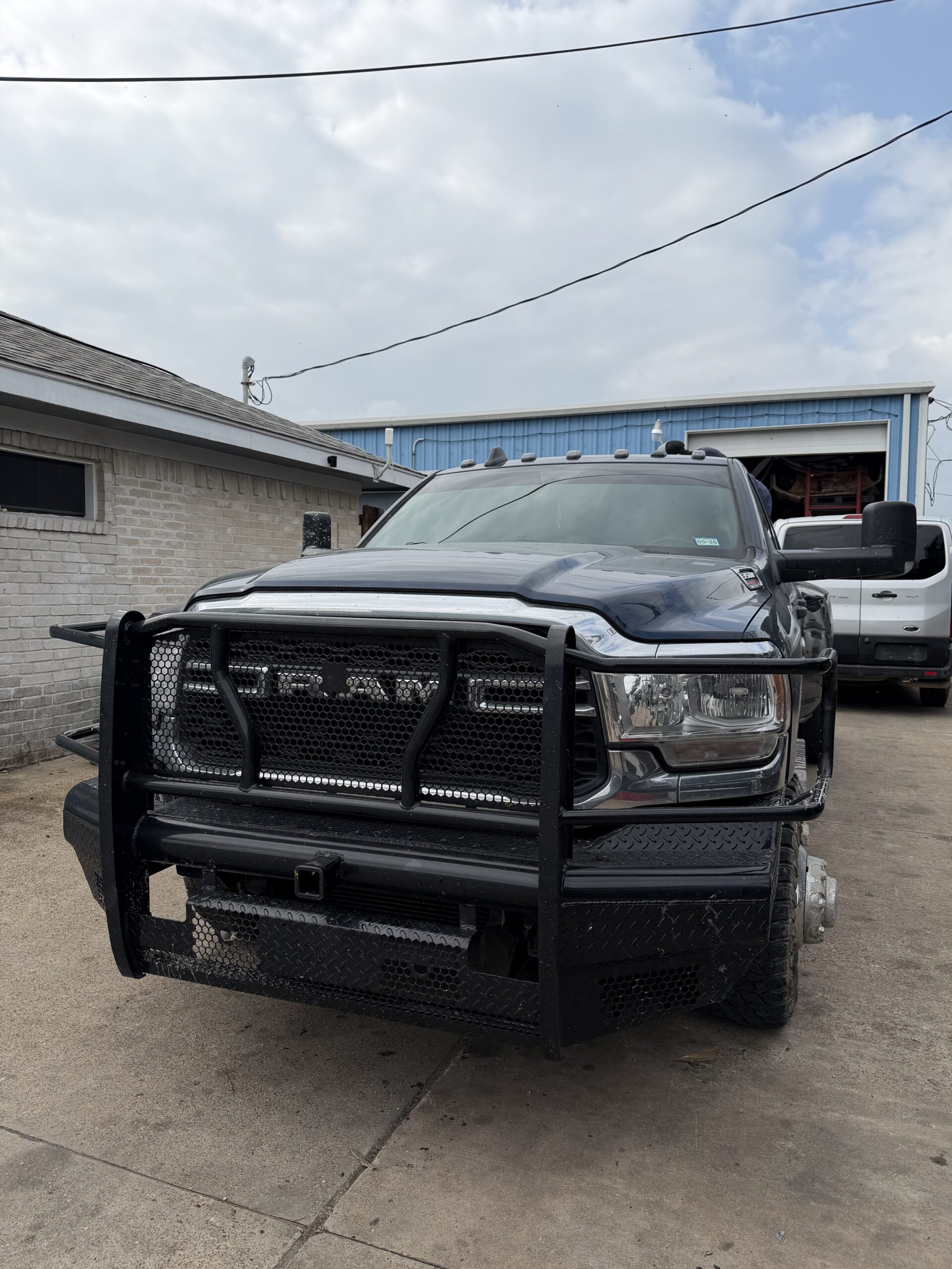 Truck bumper replacement cost — Ram with aftermarket steel front bumper installed at Texas Truck Parts
