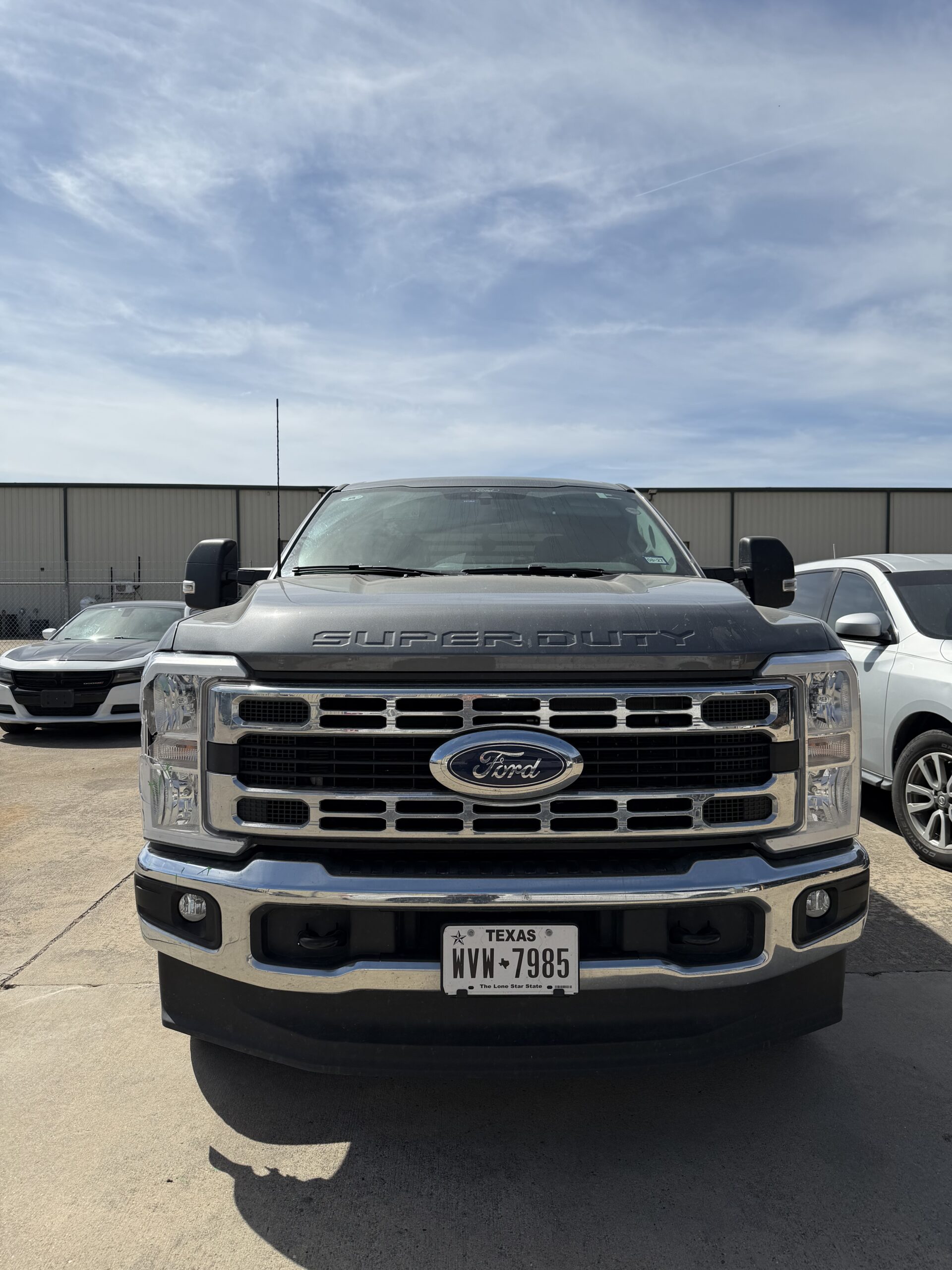 OEM vs aftermarket front bumper — factory OEM front bumper on pallet ready for truck replacement