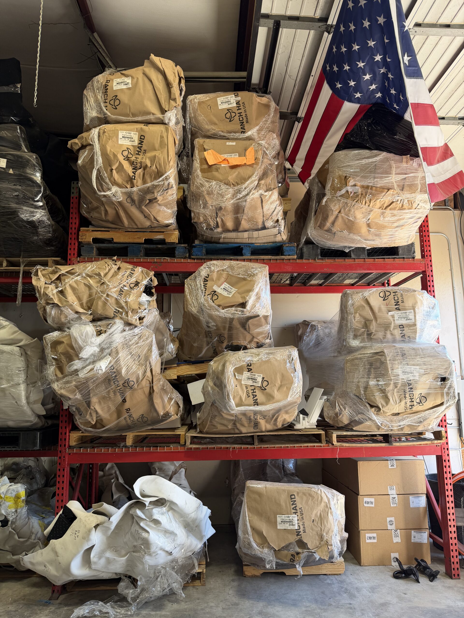 Aftermarket front replacement bumpers on warehouse racks at Texas Truck Parts